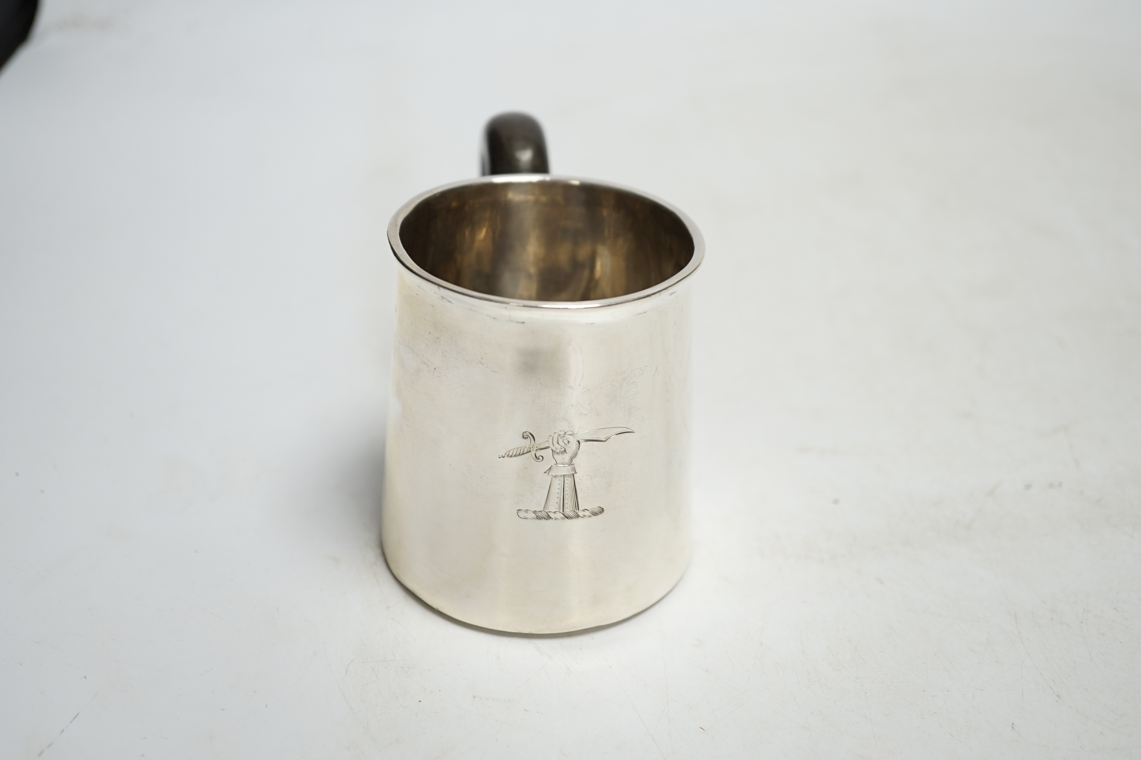 An early 18th century silver mug, with wooden handle, marks rubbed, height 78mm. Condition - poor